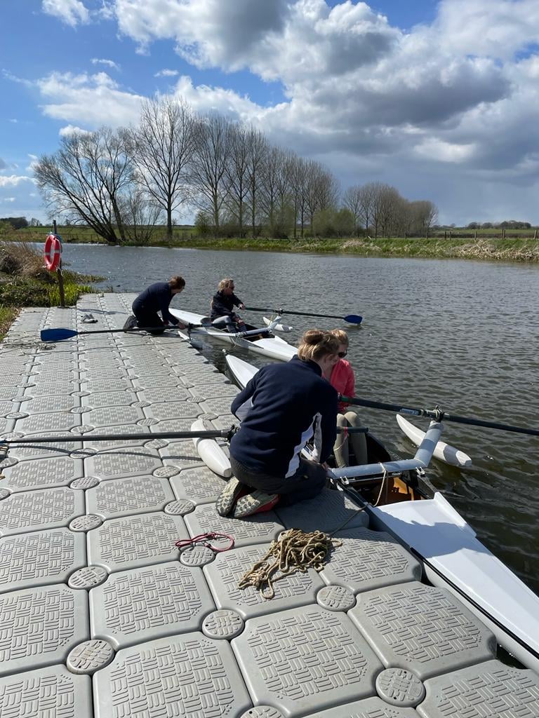 Multiple students preparing boats
